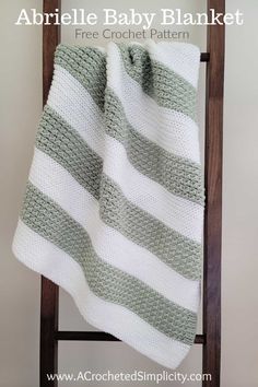 a crocheted baby blanket sitting on top of a chair