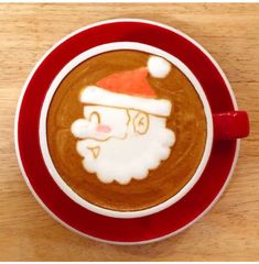 a cup of cappuccino with a santa face drawn on it