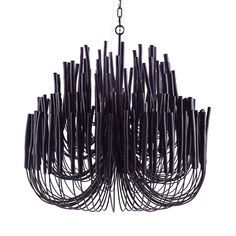 a black chandelier hanging from a chain with lots of sticks sticking out of it