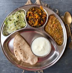 a metal plate topped with different types of food