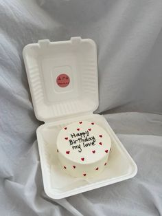 a white cake in a foam container with red hearts on the inside and writing happy birthday my love