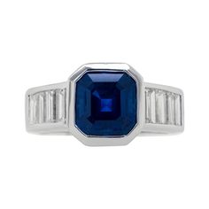 18k white gold sapphire and diamond ring features 3.31 ct asscher cut share sapphire and 1.15 carats of emerald diamonds on the side all in bezel setting White Gold Sapphire, Sapphire And Diamond Ring, Asscher Cut, White Gold Ring, Emerald Diamond, Jewelry Rings Engagement, White Gold Rings, Bezel Setting, Ring Verlobung