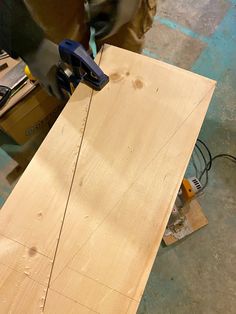 a person using a power tool on a piece of wood that is being worked on