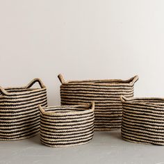 three black and white striped baskets sitting next to each other