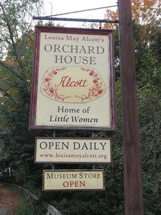 a sign for the orchard house hotel and little women's open daily museum store