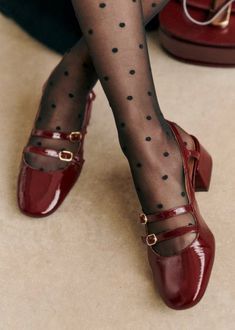 a woman wearing red shoes and polka dot stockings