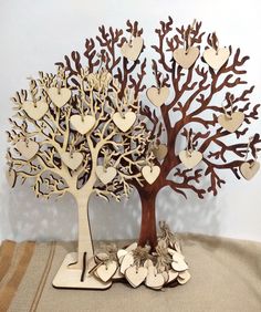 two wooden trees with hearts and leaves on each tree, one is cut out to look like the other