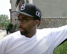 a man wearing glasses and a baseball cap