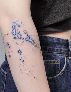 a woman's arm with blue stars on it