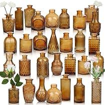 a large collection of vases with flowers in them and on the bottom one is filled with water