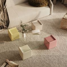 a living room with various colored furniture on the floor and in front of a white couch