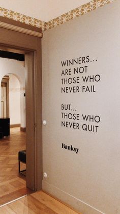 a wall with a quote on it that says winners are not those who never fail but those who never quit