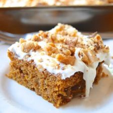 a piece of cake sitting on top of a white plate next to a casserole dish