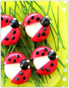 four ladybugs are sitting on top of some green grass with white and black dots