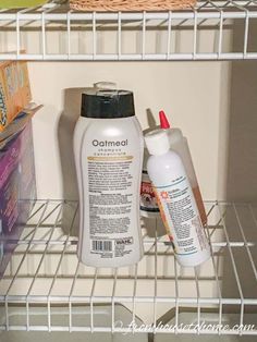 two bottles of shampoo, lotion and sunscreen are sitting on the shelf