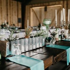 the table is set with candles and vases