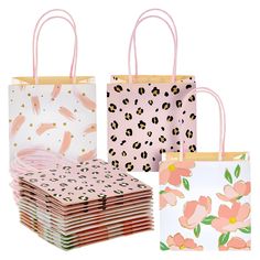 three bags with pink flowers on them