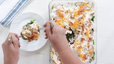 a person eating food from a white plate