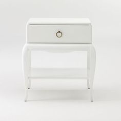 a white nightstand with two drawers on one side and an open drawer on the other