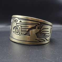 "VINTAGE KABANA BRACELET DESCRIPTION: This handsome bracelet is a vintage piece from Kabana, makers of fine southwestern jewelry since 1975. Images from the Pacific Northwest grace this heavy gauge sterling silver cuff. This bracelet will be a treasured addition to your collection of fine vintage Southwestern jewelry. MEASUREMENTS: Interior of the cuff measures 5 3/4\" with an additional 1 3/8\" non-adjustable gap. Total circumference: 7 1/8\" Measures 2 1/2\" straight across the widest part of Antique Gold Bangle With Antique Finish, Unique Adjustable Bracelets With Antique Finish, Unique Adjustable Bracelet With Antique Finish, Adjustable Bracelet With Antique Finish, Handmade Antique Gold Bracelet, Unique Etched Ceremonial Jewelry, Nickel-free Bronze Bracelet Jewelry, Antique Nickel-free Bracelet, Adjustable Antique Finish Jewelry Bracelet