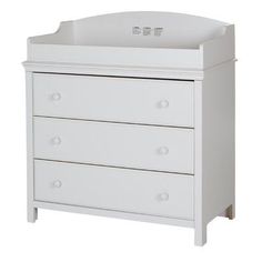 a white baby crib with three drawers