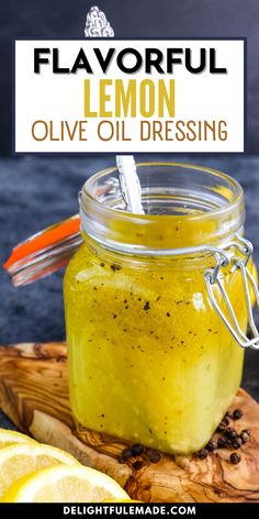 a glass jar filled with lemon olive oil sitting on top of a wooden cutting board