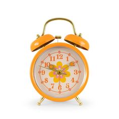 an orange alarm clock on a white background