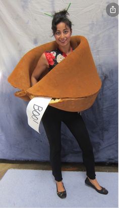 a woman is posing in a costume made to look like a cowgirl with horns and flowers on her head