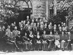 an old black and white photo of people in front of a building