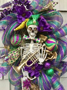 a skeleton wreath with purple and green decorations