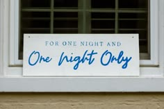 a one night only sign in front of a window