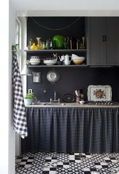 a kitchen with black and white checkered flooring