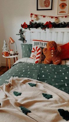 a teddy bear sitting on top of a bed in a room with christmas decorations and decor