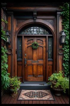 a wooden door surrounded by greenery and potted plants