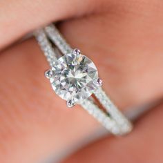 a woman's hand with a diamond ring on her finger and an engagement band