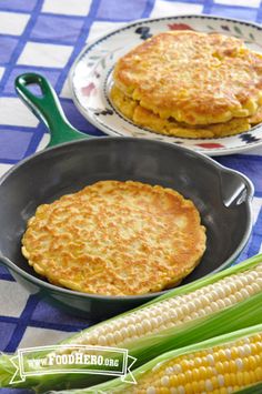 corn on the cob and two plates with pancakes