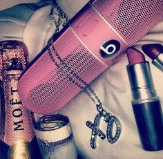 the contents of a woman's purse including lipstick, perfume bottle and other items