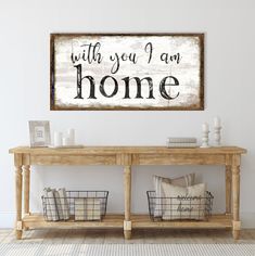 a wooden sign that says with you i am home on the wall above a table