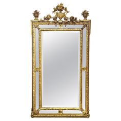 an ornate gold framed mirror against a white background