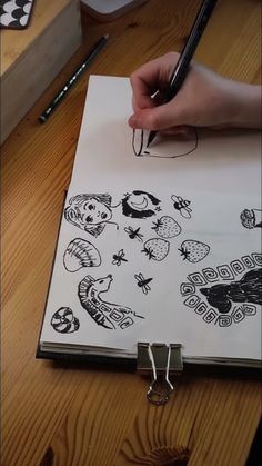 someone is drawing pictures on a piece of paper