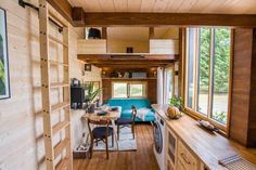 the interior of a tiny home with wood paneling