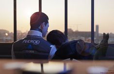 two people sitting on a window sill looking out at the city