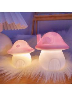 two little mushroom lamps sitting on top of a table