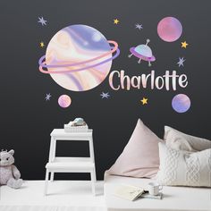 a child's bedroom with a wall decal that says charlotte on the outer planets