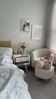 a bedroom with a bed, chair and pictures on the wall