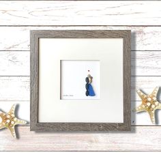 a white frame with a blue and black bird in the middle, two starfish on the side