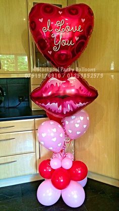 some balloons are stacked on top of each other in the shape of lips and hearts