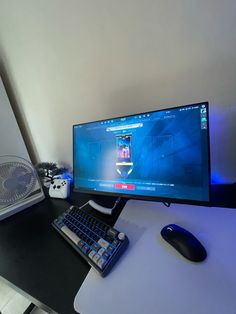 a computer monitor sitting on top of a desk next to a keyboard and mouse,