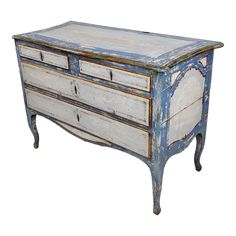 an old blue and white dresser with drawers