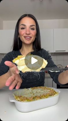 a woman holding up a piece of food in her hands